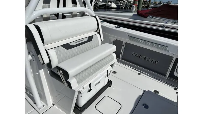 Slide: The Image of 2025 Blackfin 302 CC boat interior with white seating and storage compartments. - 6