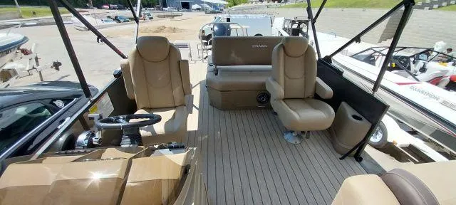 Slide: The Image of 2024 Sylvan Mirage 8520 CLZ DH pontoon boat interior with beige seating and steering console. - 6