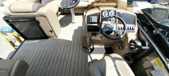 Slide: The Image of 2024 Sylvan Mirage 8520 CLZ DH boat interior with steering console and seating area. - 7