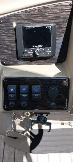 Slide: The Image of 2024 Sylvan Mirage 8520 CLZ DH dashboard with audio controls and switches. - 8