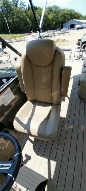 Slide: The Image of 2024 Sylvan Mirage 8520 CLZ DH boat seat with beige upholstery on deck. - 9