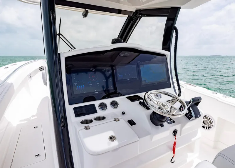 Slide: The Image of 2026 Blackwater 41 Sportfish helm with advanced navigation displays and steering wheel. - 12