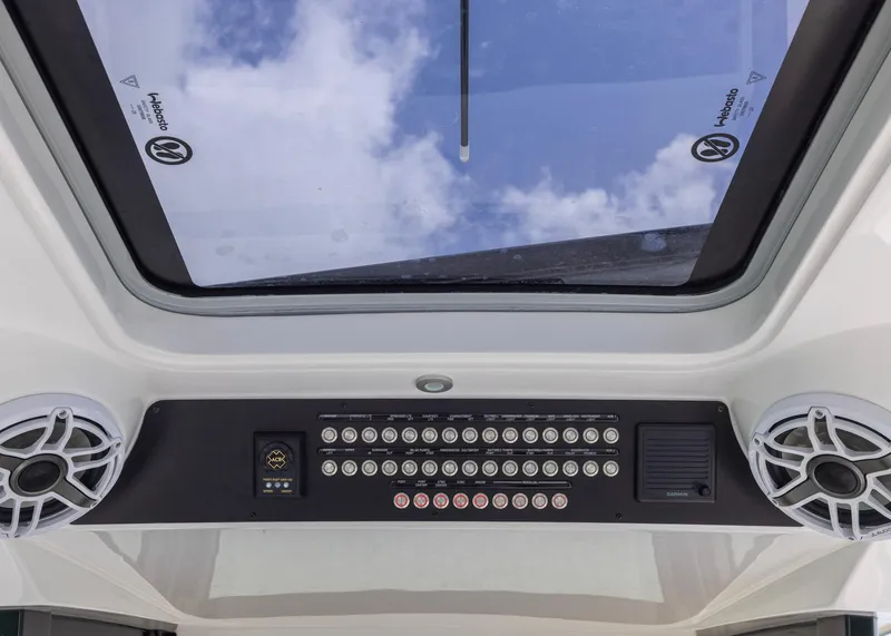 Slide: The Image of Control panel and speakers inside 2026 Blackwater 41 Sportfish boat, viewed through a sunroof. - 15