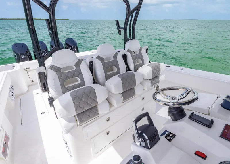 Slide: The Image of 2026 Blackwater 41 Sportfish boat interior with luxury seating and steering wheel on open water. - 18