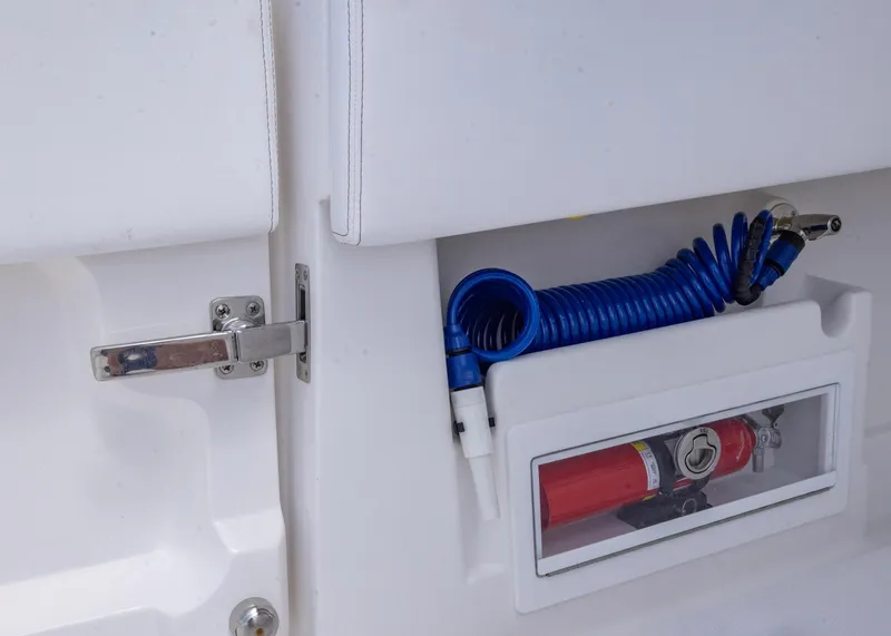 Slide: The Image of Storage compartment on 2026 Blackwater 41 Sportfish boat with blue hose and fire extinguisher. - 32