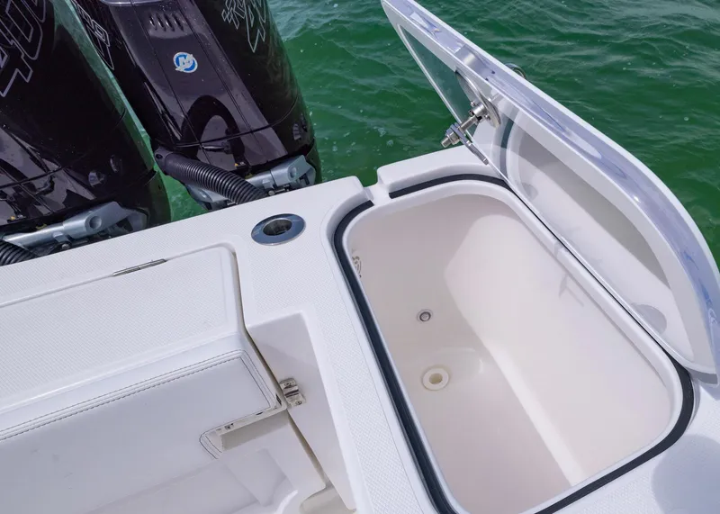 Slide: The Image of Open storage compartment on 2026 Blackwater 41 Sportfish boat, with twin outboard motors visible. - 38