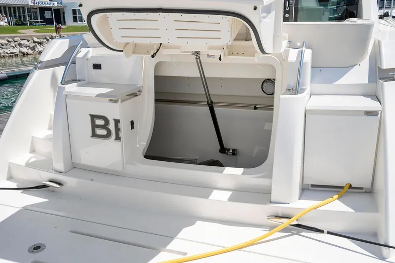 Slide: The Image of 2022 Tiara Yachts C49 Coupe yacht storage compartment open at the stern. - 10