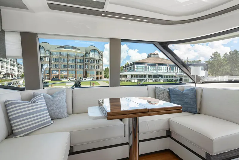 Slide: The Image of Interior of 2022 Tiara Yachts C49 Coupe with elegant seating and scenic window view. - 19