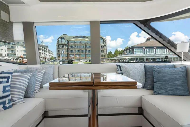 Slide: The Image of Interior of 2022 Tiara Yachts C49 Coupe with elegant seating and scenic marina view. - 20