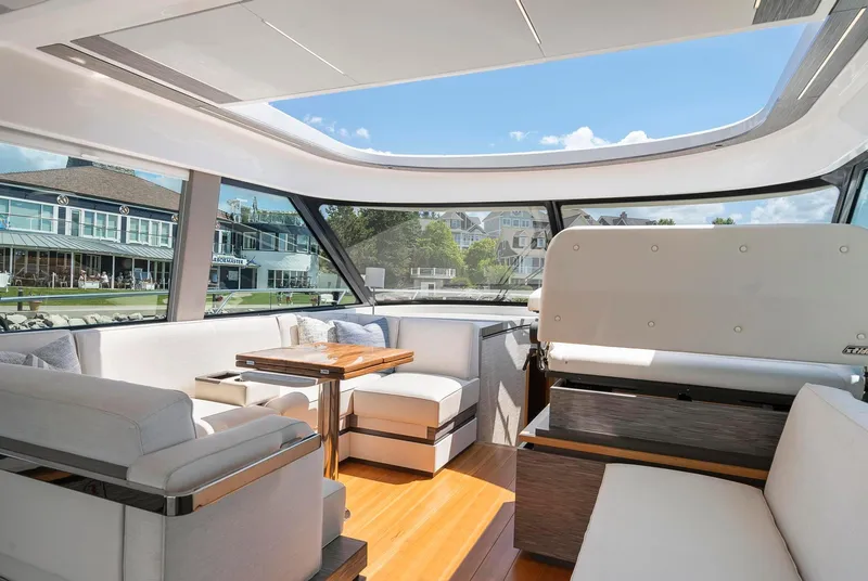 Slide: The Image of Luxurious interior of 2022 Tiara Yachts C49 Coupe with panoramic windows and elegant seating. - 21