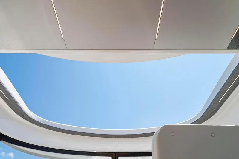 Slide: The Image of Open sunroof view on 2022 Tiara Yachts C49 Coupe, showcasing clear blue sky. - 30