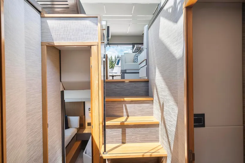 Slide: The Image of Interior of 2022 Tiara Yachts C49 Coupe, featuring wooden stairs and modern design elements. - 31