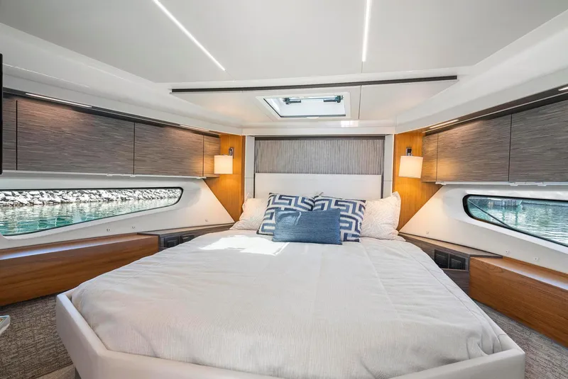 Slide: The Image of Luxurious bedroom interior of 2022 Tiara Yachts C49 Coupe with modern design and natural light. - 32