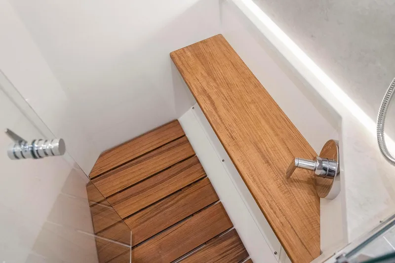 Slide: The Image of 2022 Tiara Yachts C49 Coupe shower with wooden bench and floor. - 36