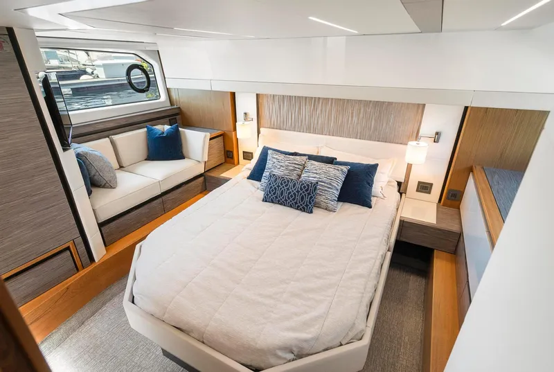 Slide: The Image of Luxurious bedroom interior of 2022 Tiara Yachts C49 Coupe with modern design and cozy seating. - 38