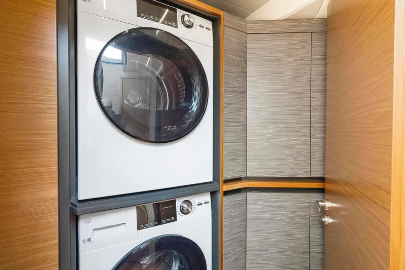Slide: The Image of Stacked washer and dryer in 2022 Tiara Yachts C49 Coupe interior. - 47
