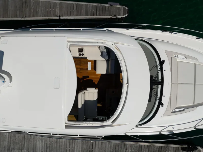 Slide: The Image of Overhead view of 2022 Tiara Yachts C49 Coupe docked, showcasing sleek design and spacious interior. - 5
