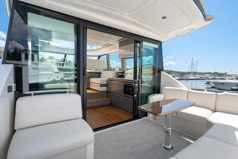 Slide: The Image of 2022 Tiara Yachts C49 Coupe interior with luxurious seating and modern design. - 8