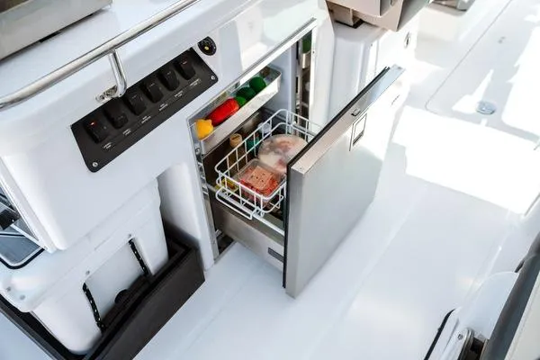 Slide: The Image of 2025 Blackfin 302 DC boat with open refrigerator drawer. - 10
