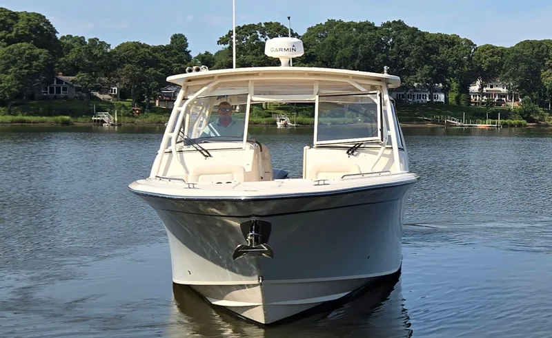 Slide: The Image of 2017 Grady-White Freedom 335 boat on calm water, front view. - 4