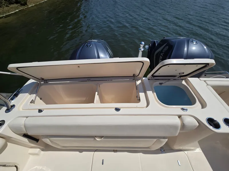 Slide: The Image of 2017 Grady-White Freedom 335 boat with open storage compartments and dual Yamaha engines. - 8