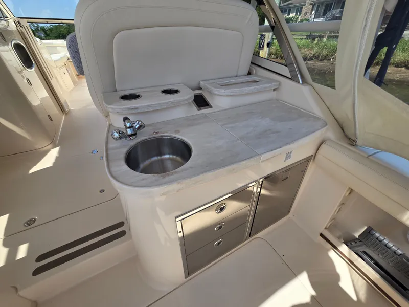 Slide: The Image of 2017 Grady-White Freedom 335 boat interior with sink and storage cabinets. - 9