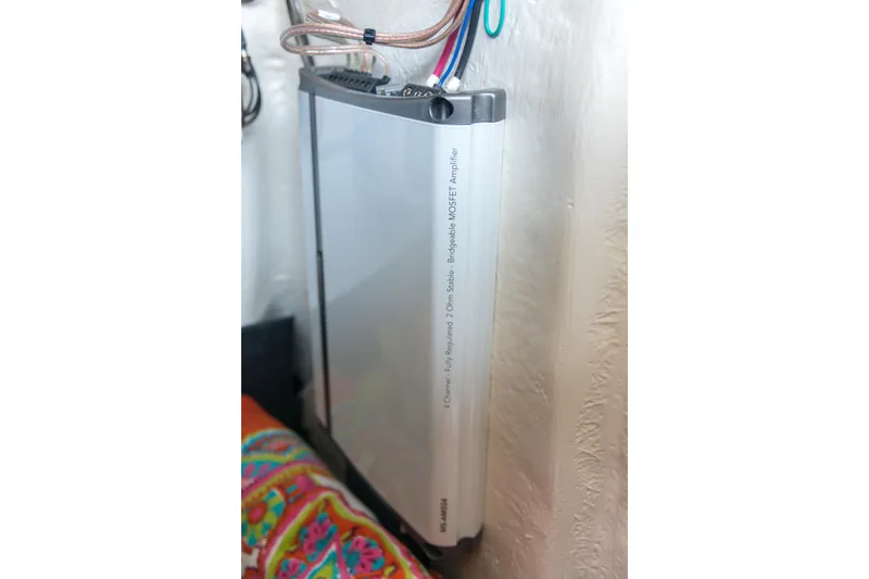 Slide: The Image of 2026 Regal 21 OBX boat amplifier, 4-channel, fully regulated, mounted on textured wall. - 17