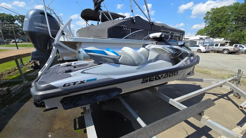 Slide: The Image of 2021 Sea-Doo GTX Limited 300 jet ski on trailer, parked outdoors. - 3