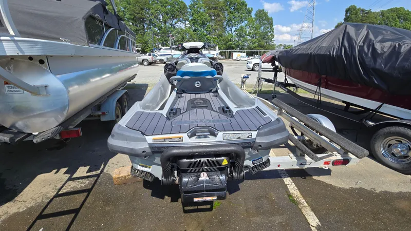 Slide: The Image of 2021 Sea-Doo GTX Limited 300 on trailer, parked beside boats, sunny day. - 4