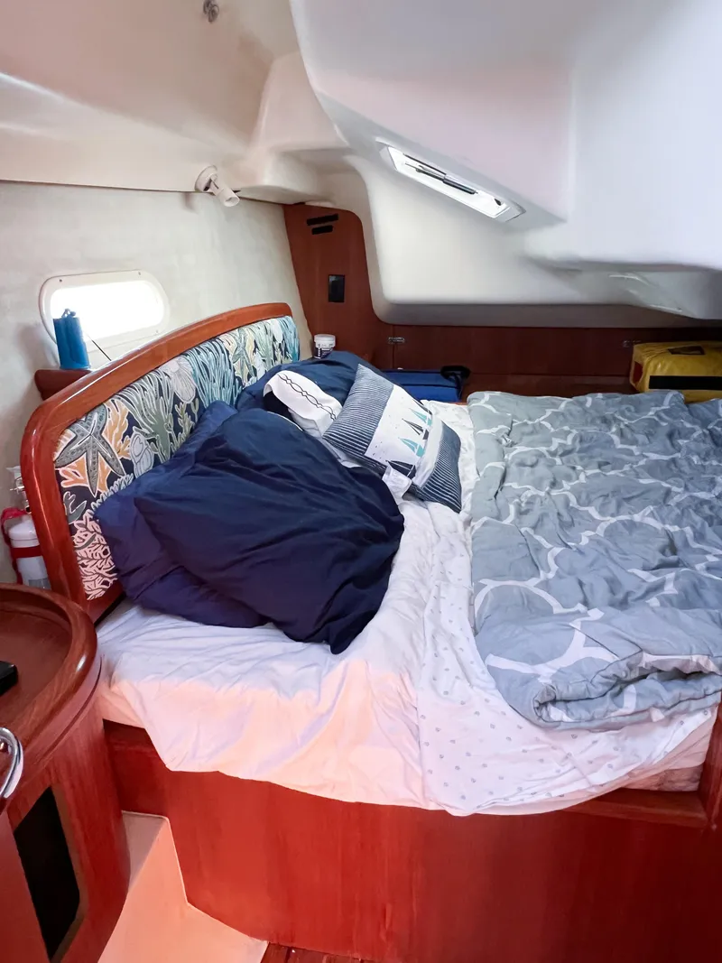 Slide: The Image of Cozy cabin interior of 2002 Hunter 356 sailboat with bed and pillows. - 12