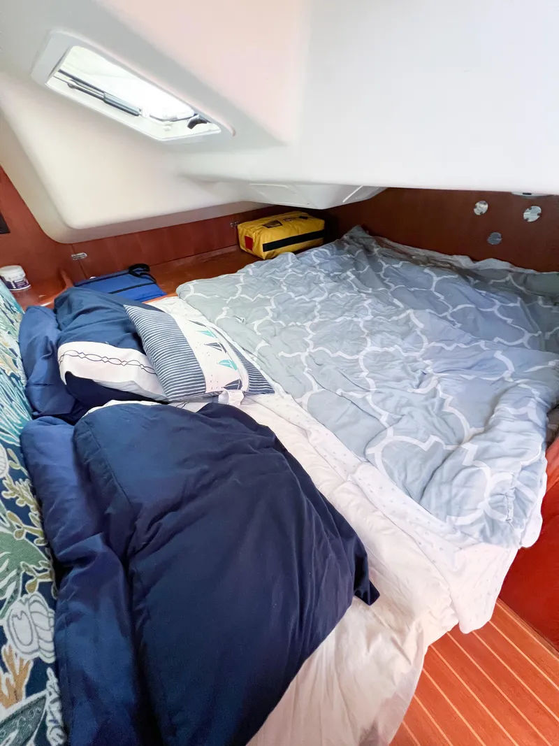 Slide: The Image of Cozy cabin interior of 2002 Hunter 356 sailboat with bed and pillows. - 13