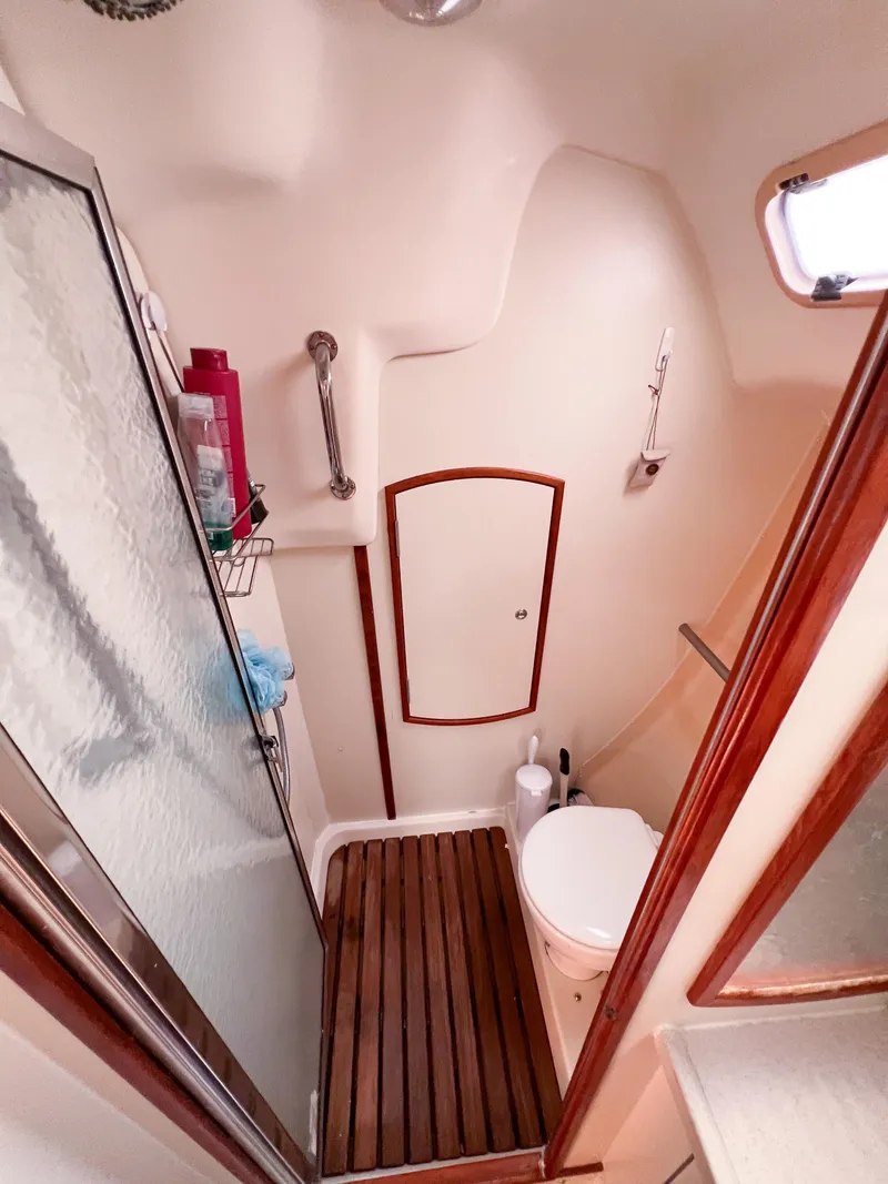Slide: The Image of Compact bathroom in a 2002 Hunter 356 sailboat, featuring a shower and toilet. - 20