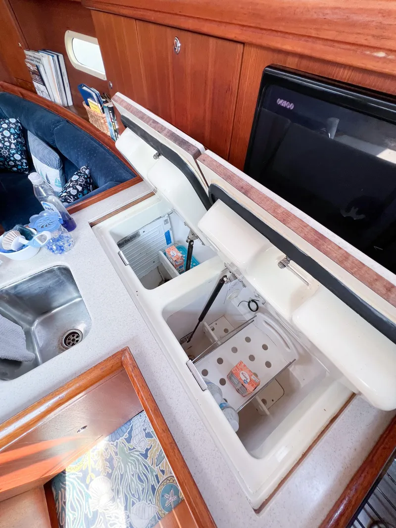 Slide: The Image of Interior of 2002 Hunter 356 yacht showing kitchen sink and storage compartments. - 24