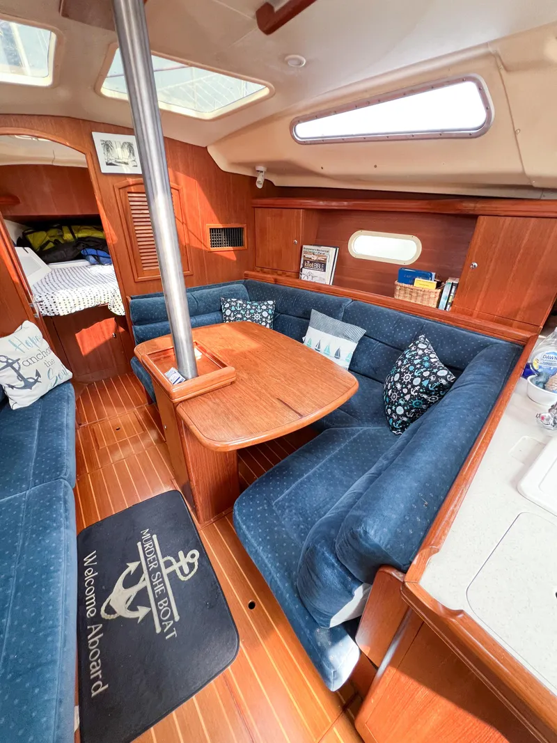 Slide: The Image of Interior of a 2002 Hunter 356 sailboat with cozy seating and wooden finishes. - 25