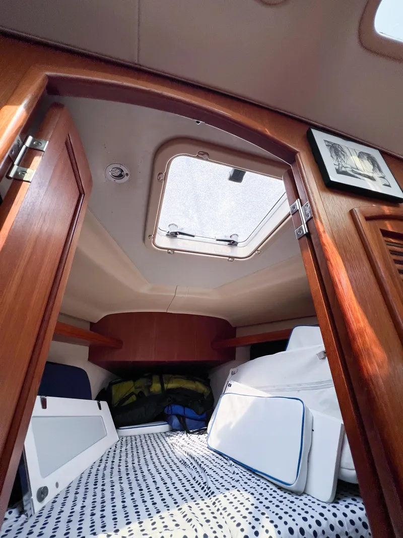 Slide: The Image of Cozy cabin interior of 2002 Hunter 356 sailboat with skylight and wooden finish. - 38