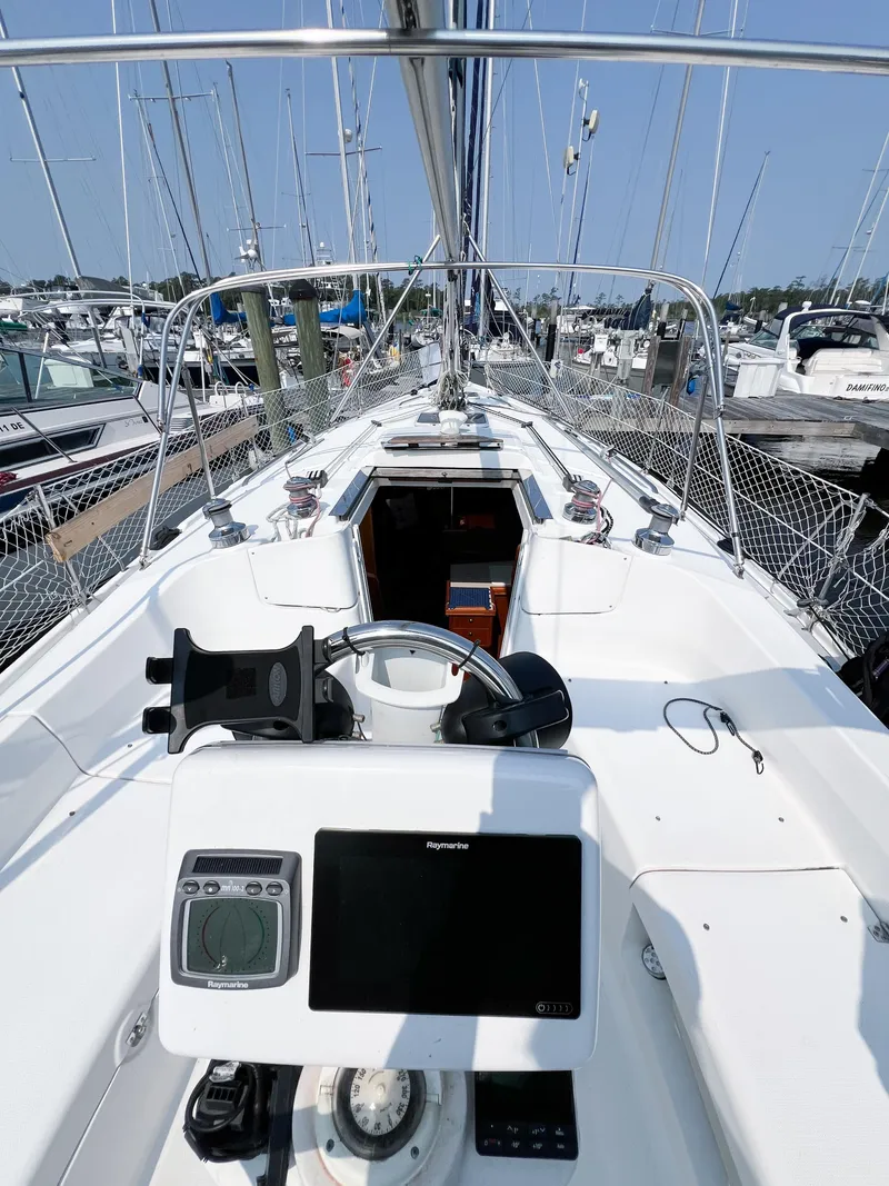 Slide: The Image of Cockpit view of a 2002 Hunter 356 sailboat docked at a marina. - 39