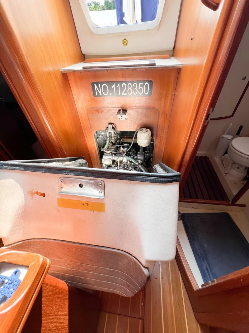 Slide: The Image of Engine compartment of a 2002 Hunter 356 sailboat, showing interior details and serial number. - 41