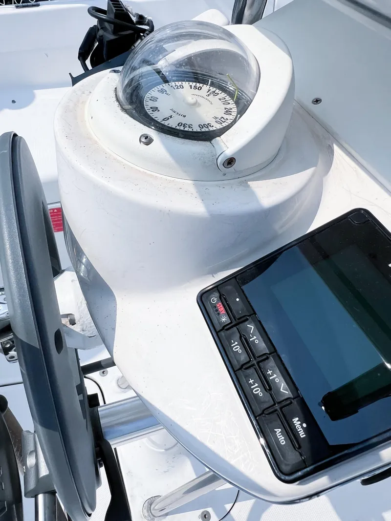 Slide: The Image of Compass and navigation controls on a 2002 Hunter 356 sailboat. - 7