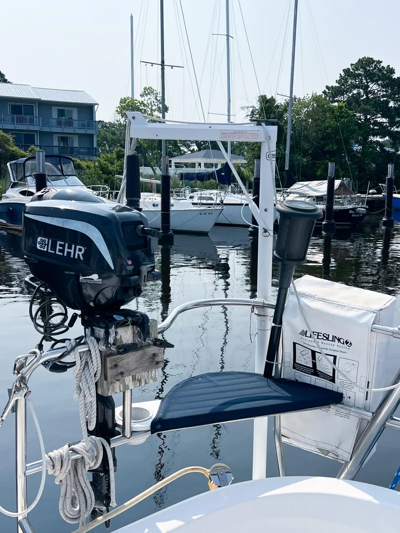 Slide: The Image of Hunter 356 sailboat with Lehr outboard motor docked at marina, 2002 model. - 9