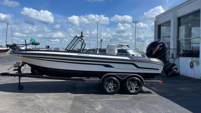The Image of 2025 Skeeter Solera 205 boat on trailer, parked outdoors under a cloudy sky. - 0