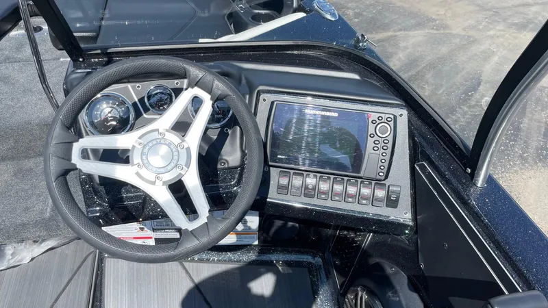 Slide: The Image of 2025 Skeeter Solera 205 boat dashboard with steering wheel and electronic display. - 6