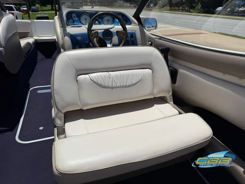 Slide: The Image of Interior of a 1998 Regal 2100 LSR boat with white seating and dashboard. - 13