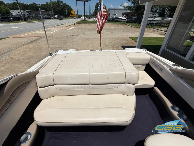 Slide: The Image of 1998 Regal 2100 LSR boat interior with beige seating and American flag. - 14