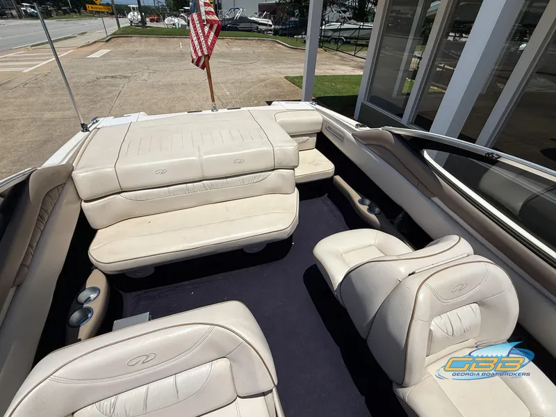 Slide: The Image of 1998 Regal 2100 LSR boat interior with white seating and American flag. - 15