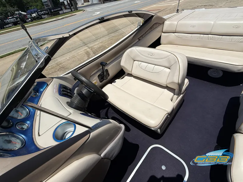 Slide: The Image of 1998 Regal 2100 LSR boat interior with beige seating and dashboard controls. - 16