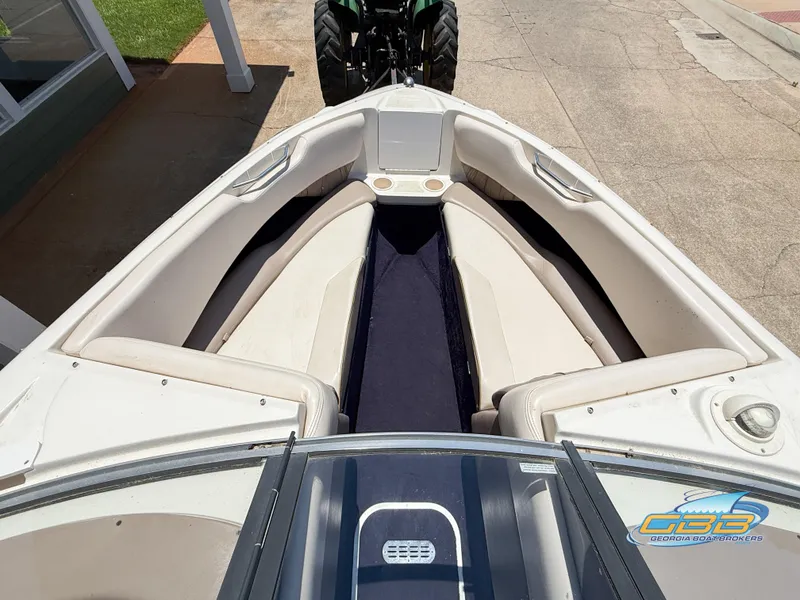 Slide: The Image of 1998 Regal 2100 LSR boat interior with beige seating and blue carpet. - 9