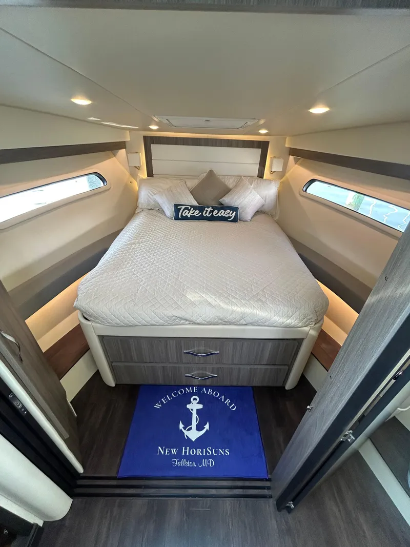 Slide: The Image of Luxurious cabin interior of 2020 Regal 38 Grande Coupe with cozy bed and nautical decor. - 15