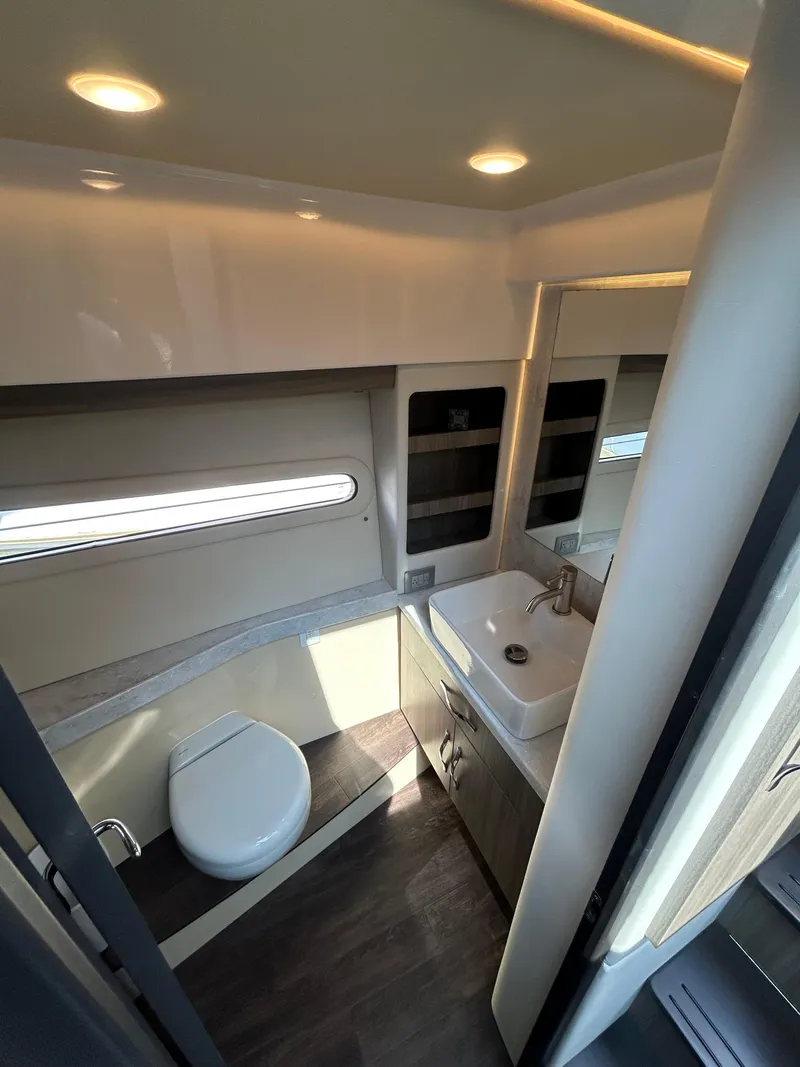 Slide: The Image of Modern bathroom interior of 2020 Regal 38 Grande Coupe yacht, featuring sleek fixtures and lighting. - 18