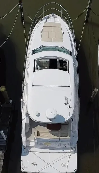 Slide: The Image of 2020 Regal 38 Grande Coupe yacht docked, aerial view showcasing sleek design and spacious deck. - 20