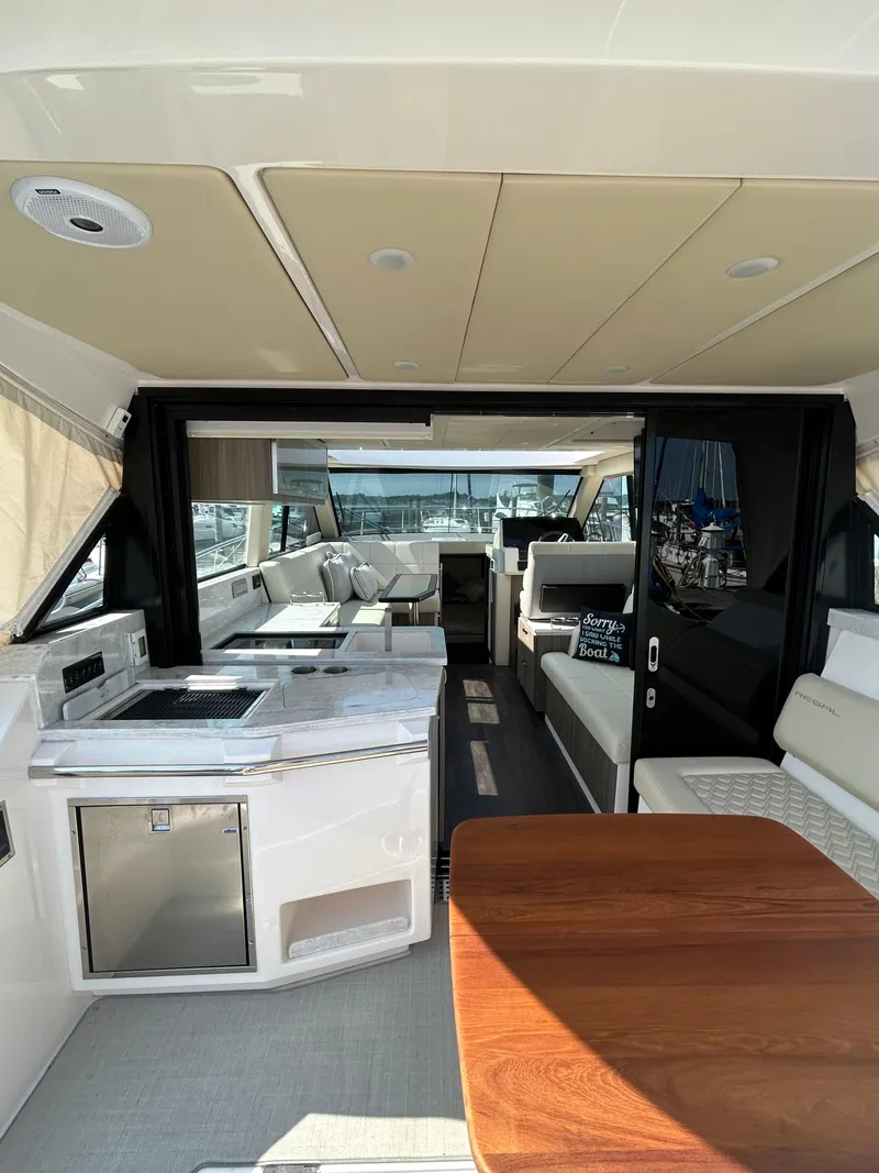 Slide: The Image of Interior view of 2020 Regal 38 Grande Coupe yacht, featuring luxurious seating and modern amenities. - 8